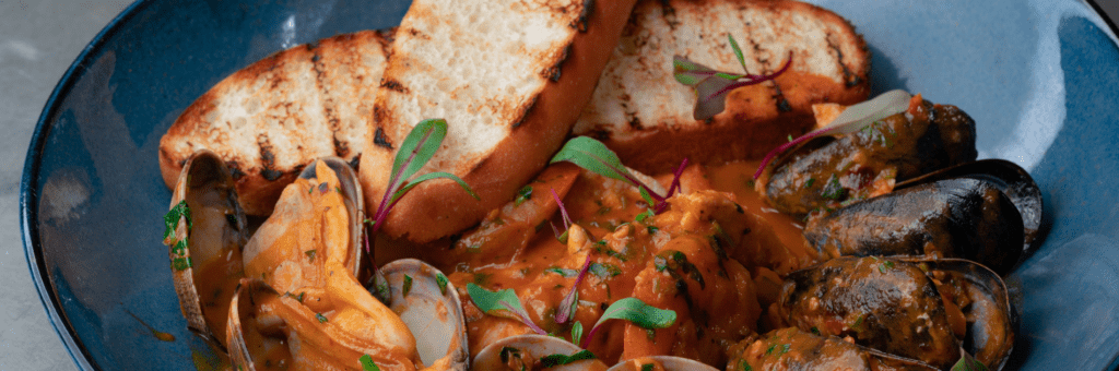 Enjoy authentic French cuisine at Brasserie du Monde - bouillabaisse